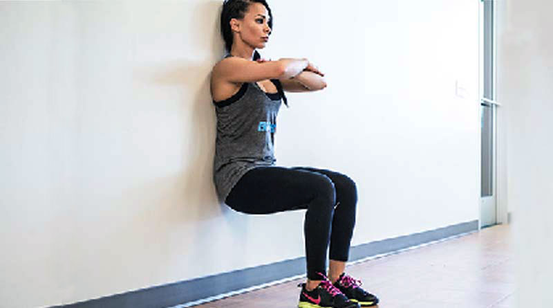 alt="a woman doing wall sits"