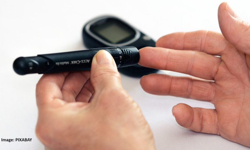 alt="man testing diabetes"