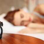 alt="woman sleeping near a watch"