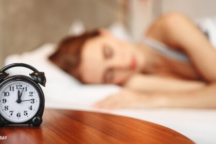 alt="woman sleeping near a watch"