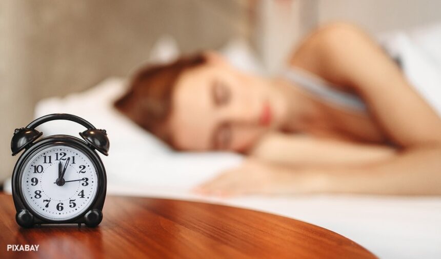 alt="woman sleeping near a watch"