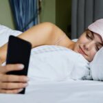 alt="smartphone screen use on bed"