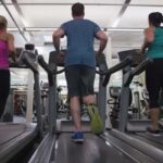 alt="Women running on treadmills at gym"