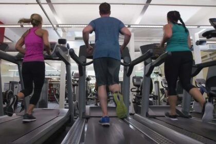 alt="Women running on treadmills at gym"